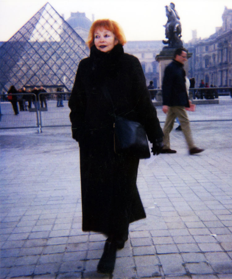 Anne Sandry walking by the Louvre